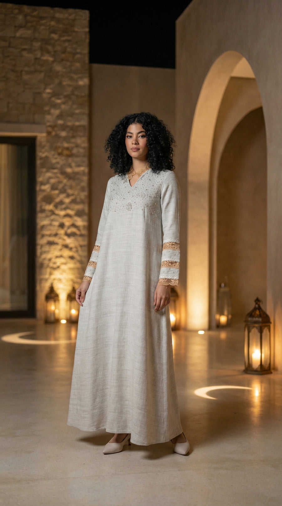 Ivory embroidered kaftan beneath lantern-lit arches