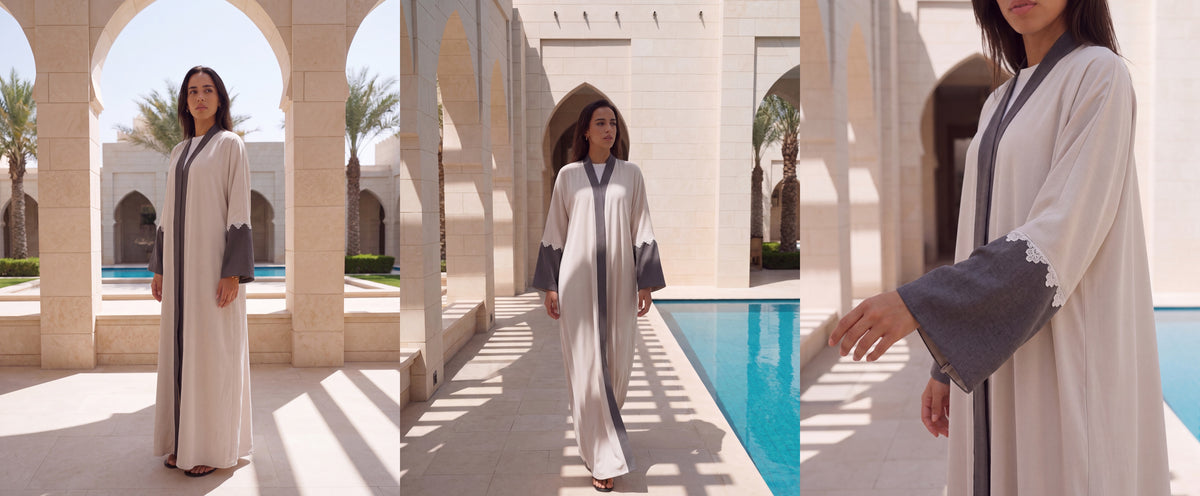 Chika beige crepe abaya with grey trim and sleeves under stone arches