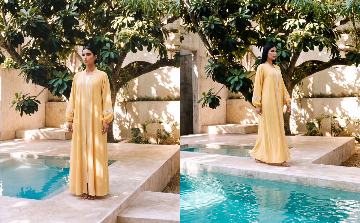 Model in the Effa yellow crepe abaya beside a garden pool