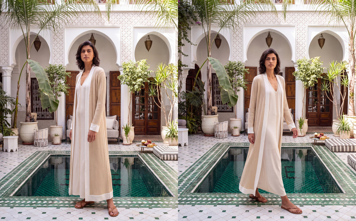 Model in the Shabaka Jameela ivory silk abaya set beside a tiled courtyard pool