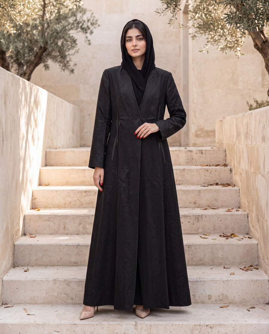 Black jacquard abaya coat on a limestone staircase
