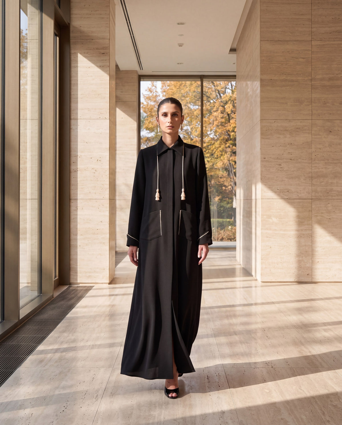 Black crepe abaya in a travertine lobby