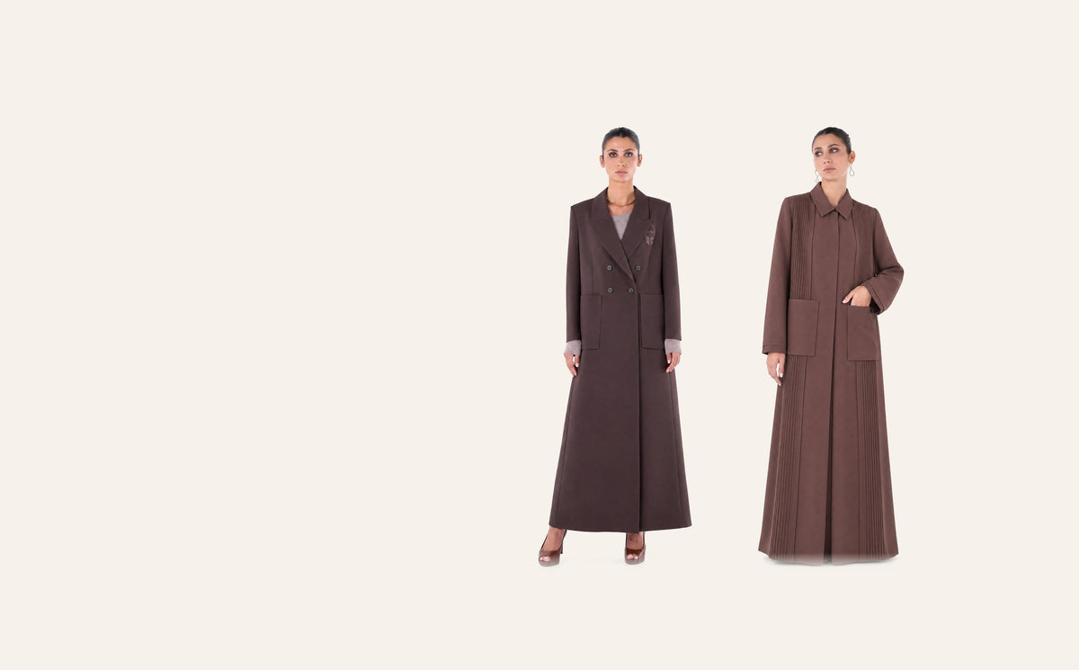 Moonlight Concept SM2651 saddle brown crepe abaya coat beside the SM2659 saddle brown crepe abaya, on a plain cream studio background
