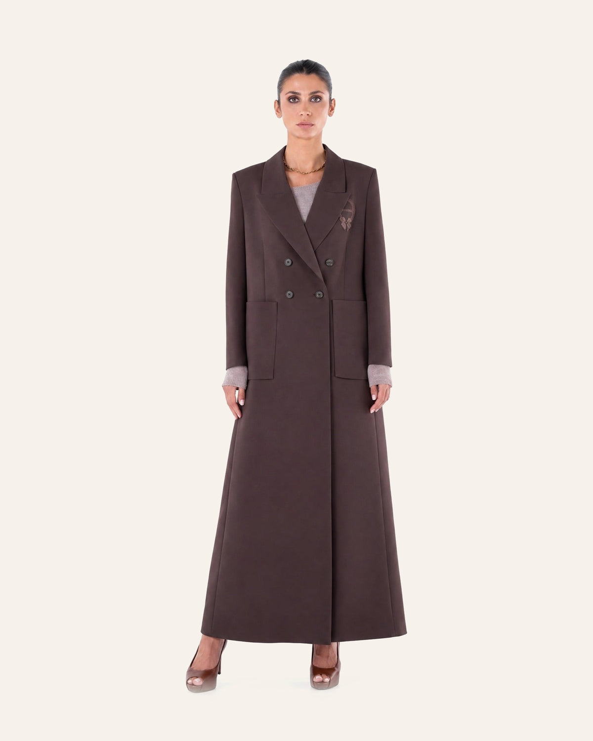 Moonlight Concept SM2651 saddle brown crepe abaya coat beside the SM2659 saddle brown crepe abaya, on a plain cream studio background