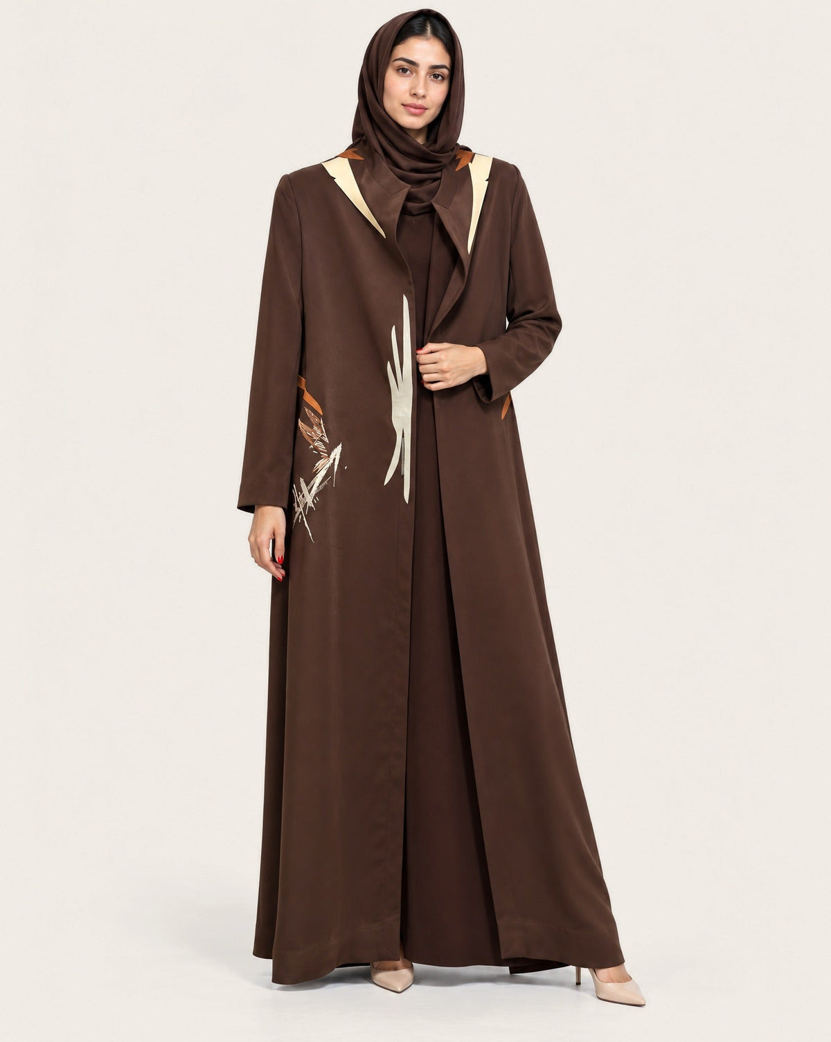 Brown crepe abaya coat with a hand-painted panel, worn open over a brown dress