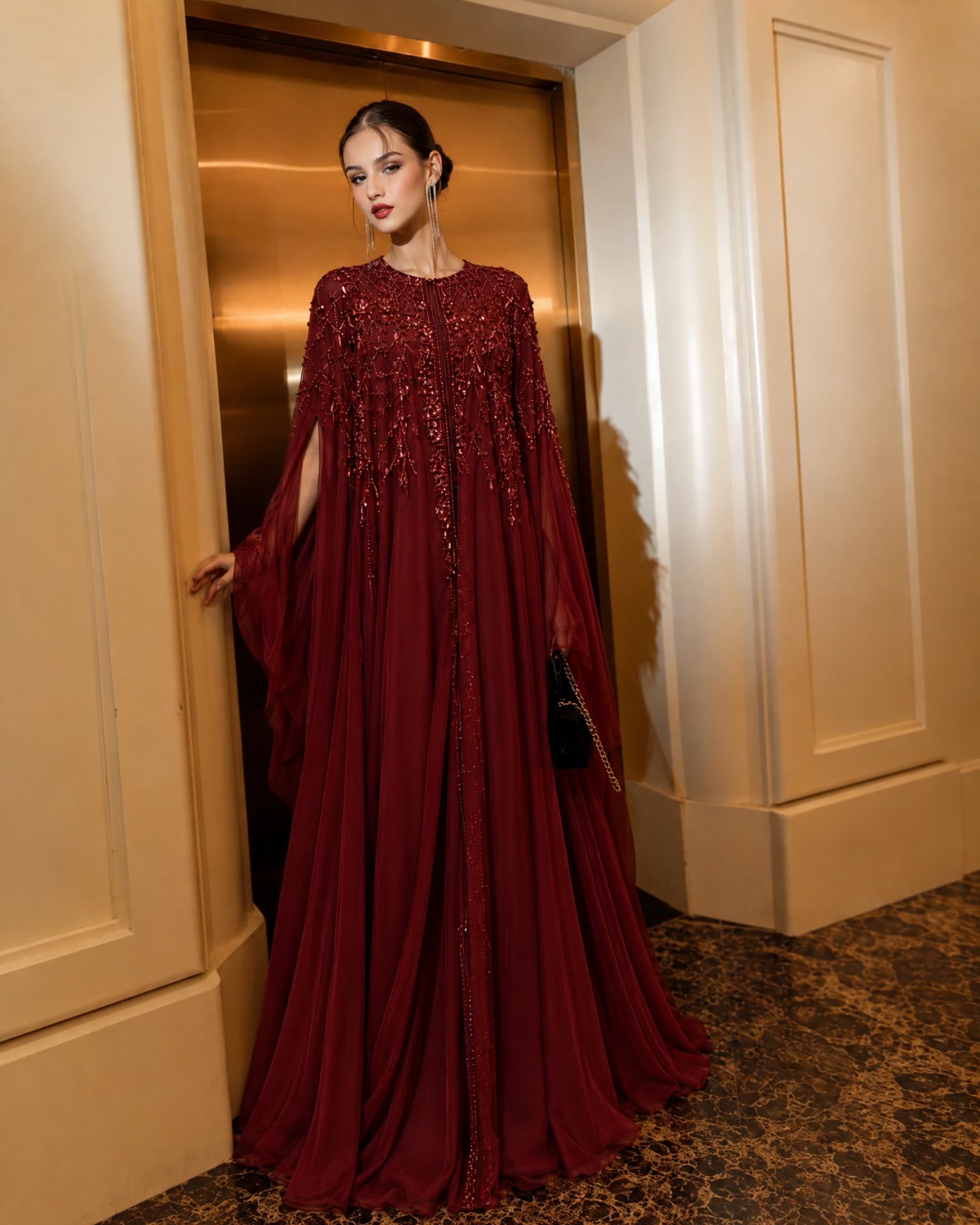 Model in a burgundy embellished cape kaftan