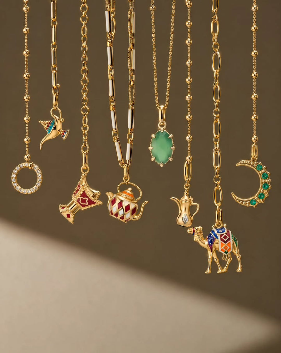 Gold charm necklaces with enamel coffee pot, camel and crescent pendants