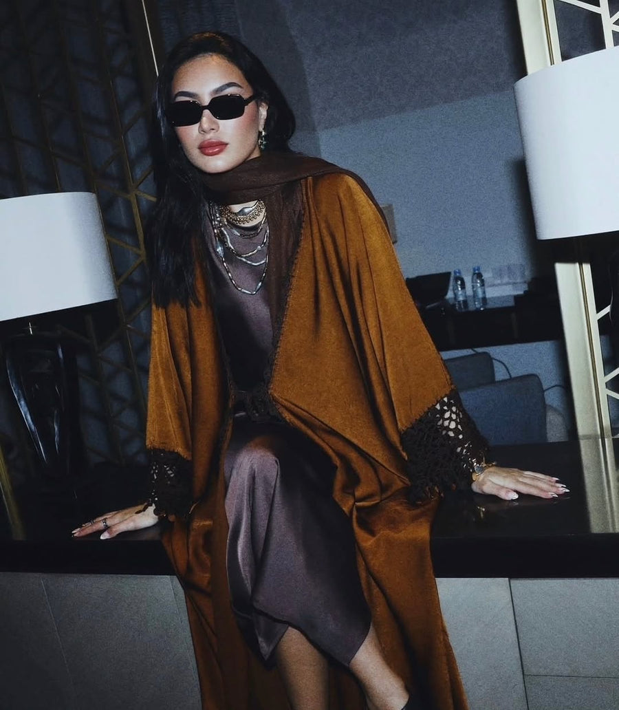 Rust silk abaya with crochet trim over a brown slip dress